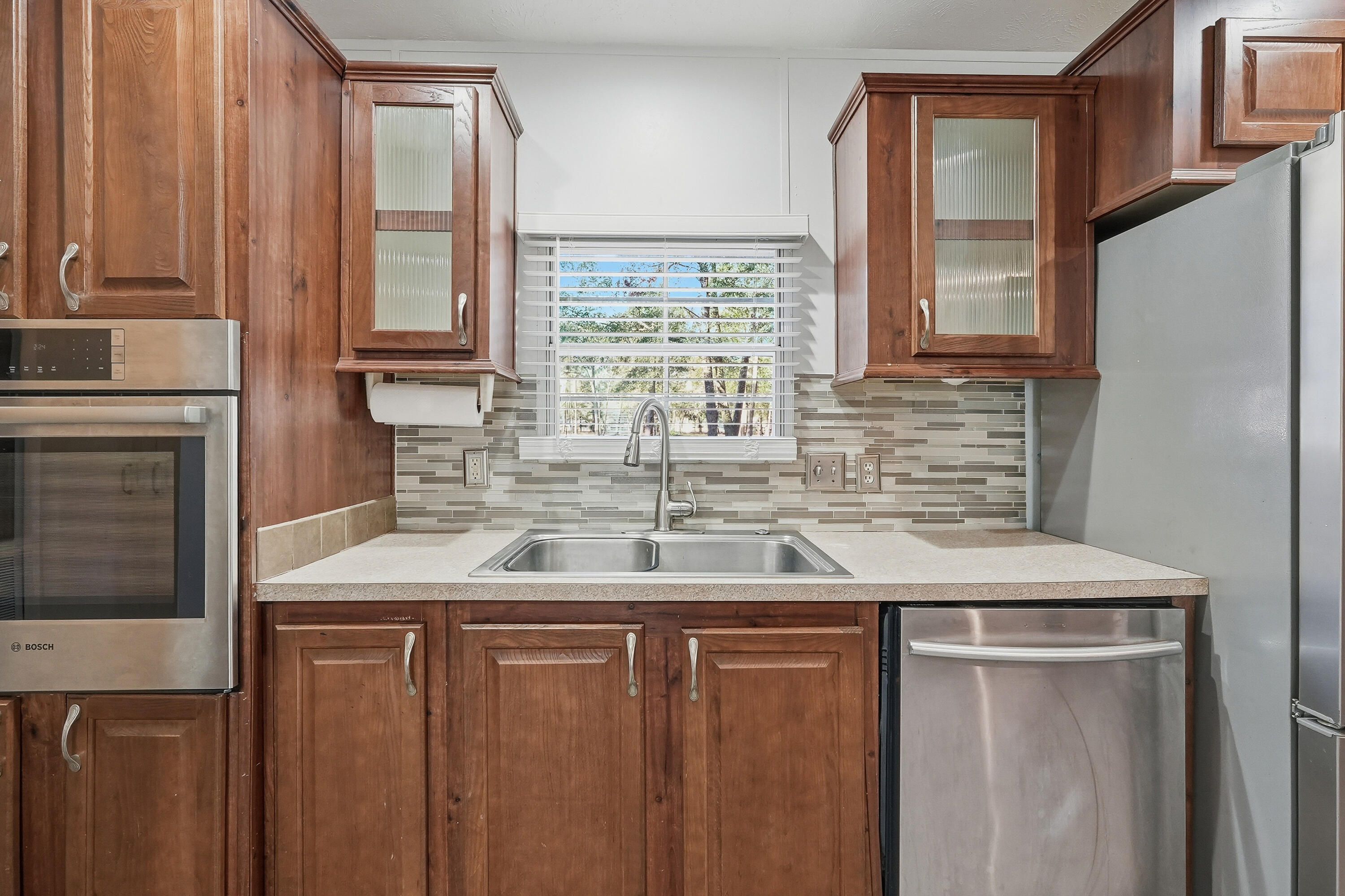 482 Roberts Road East DeFuniak Springs, FL 32433 - Photo 14 of 61 a kitchen with stainless steel appliances granite countertop a sink and a refrigerator