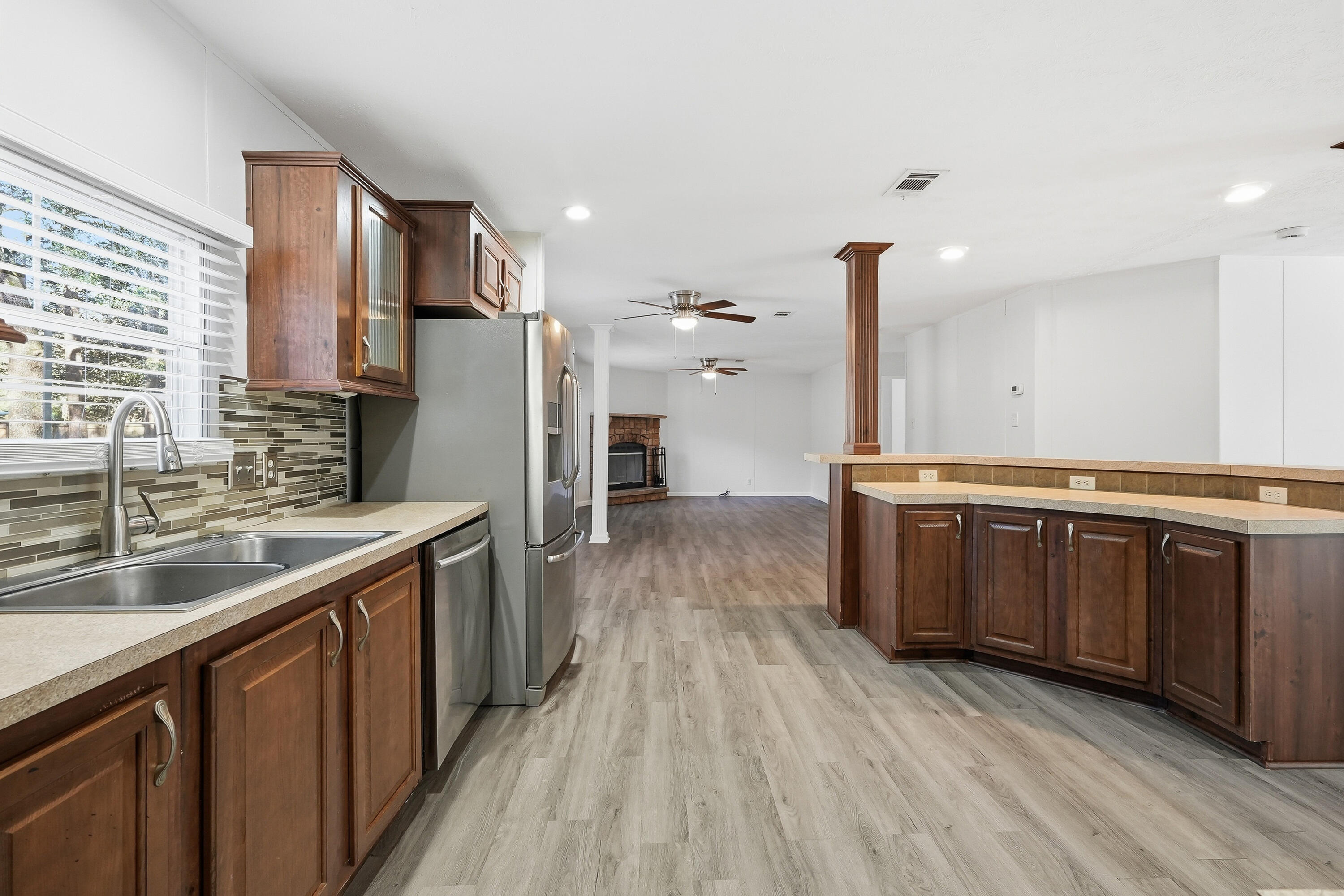 482 Roberts Road East DeFuniak Springs, FL 32433 - Photo 17 of 61 a kitchen with stainless steel appliances granite countertop a refrigerator a sink dishwasher a stove with wooden floors and cabinets