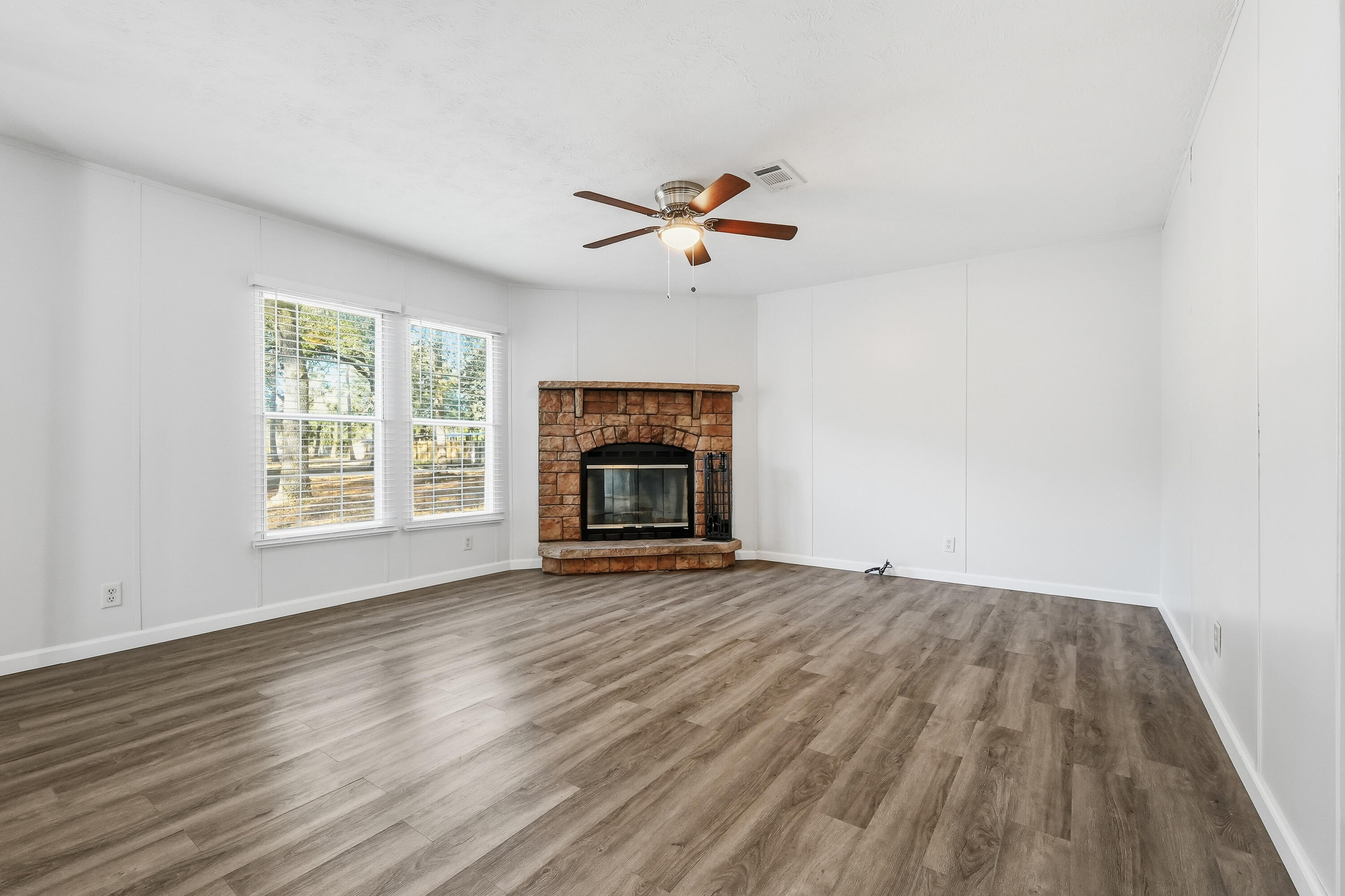 482 Roberts Road East DeFuniak Springs, FL 32433 - Photo 27 of 61 an empty room with windows and a fireplace