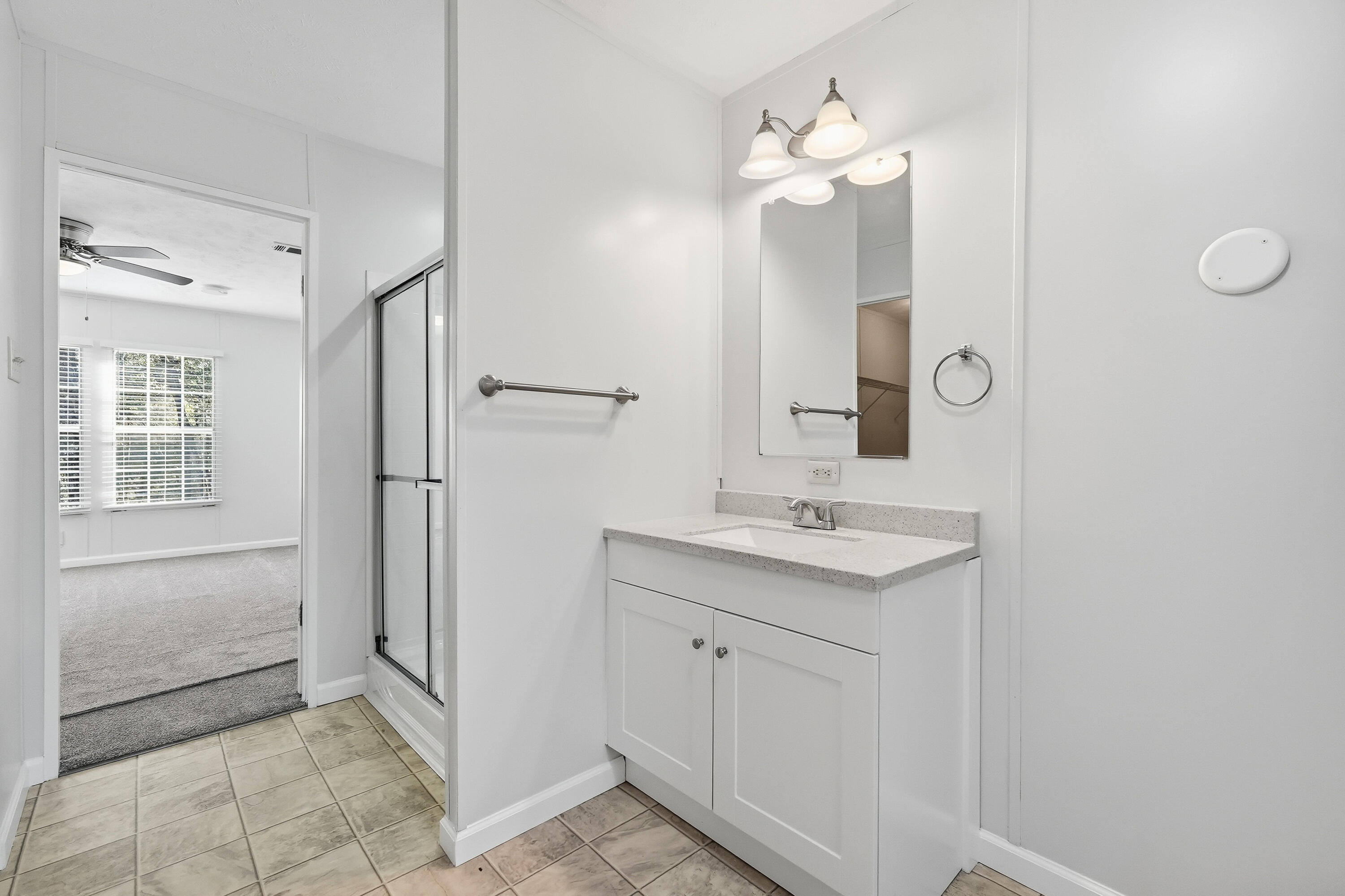 482 Roberts Road East DeFuniak Springs, FL 32433 - Photo 41 of 61 a bathroom with a sink a light fixture a vanity and a mirror