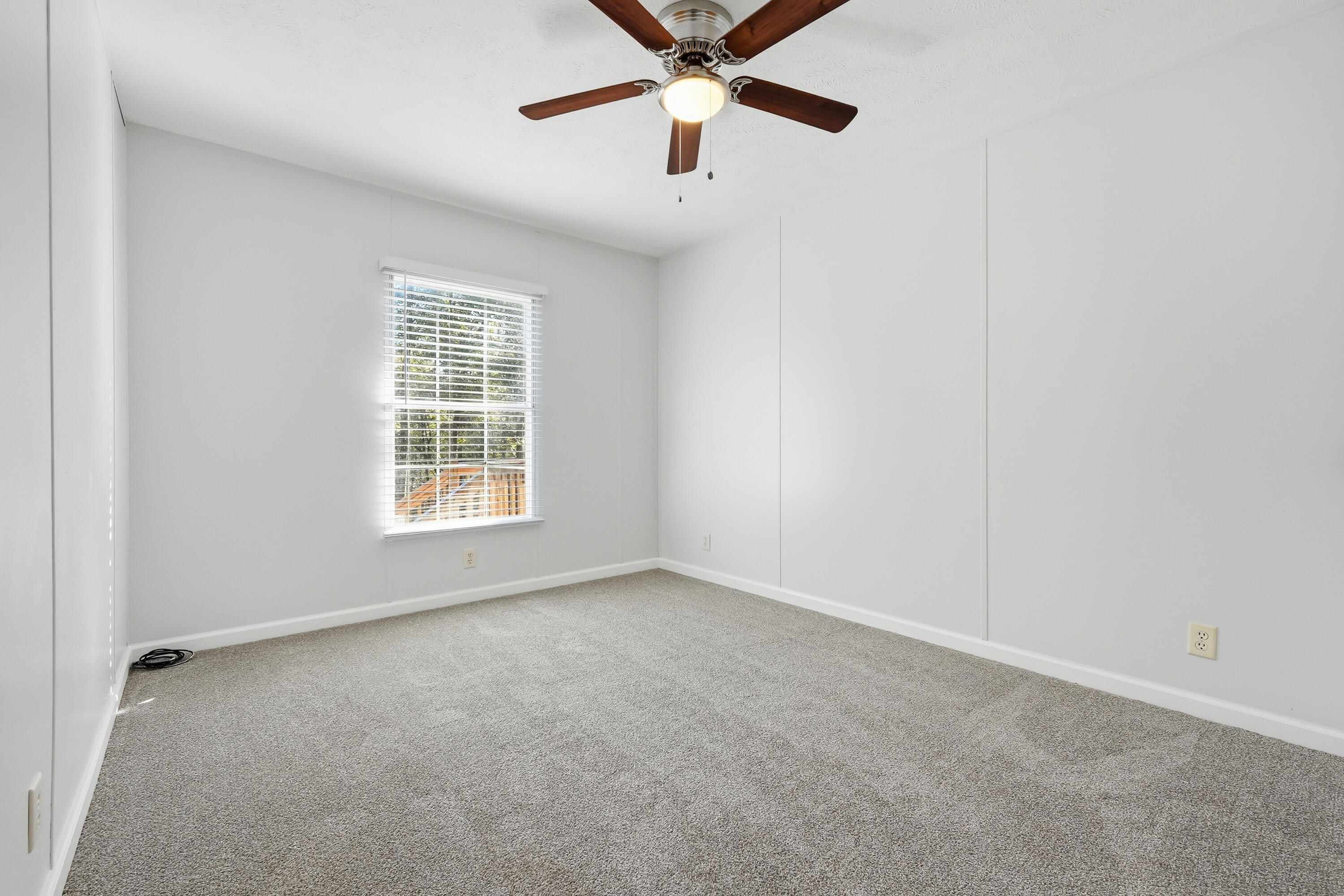 482 Roberts Road East DeFuniak Springs, FL 32433 - Photo 45 of 61 an empty room with windows and fan