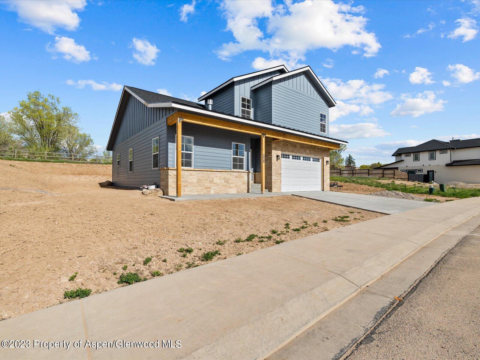 1416 Rifle Heights Drive Rifle, CO 81650 - Photo 1 of 35 a front view of a house with a yard
