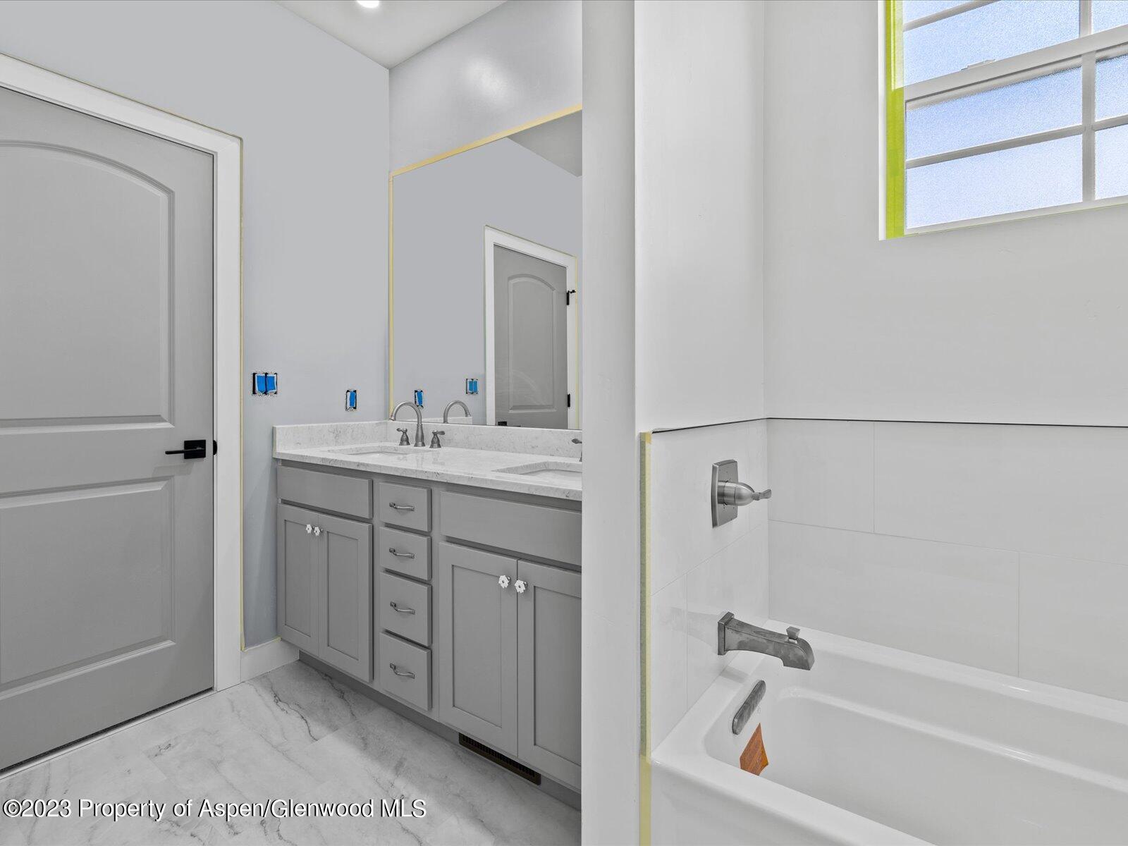 1416 Rifle Heights Drive Rifle, CO 81650 - Photo 32 of 35 a bathroom with a tub sink and mirror
