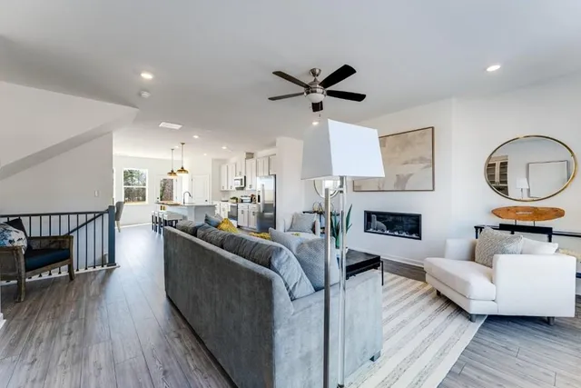 a living room with furniture kitchen and a table