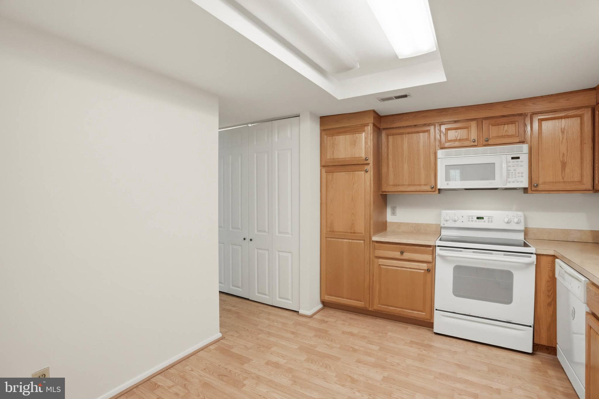 3501 Forest Edge Drive, Unit 142G Silver Spring, MD 20906 - Photo 11 of 30 a view of a kitchen with a sink and a stove top oven