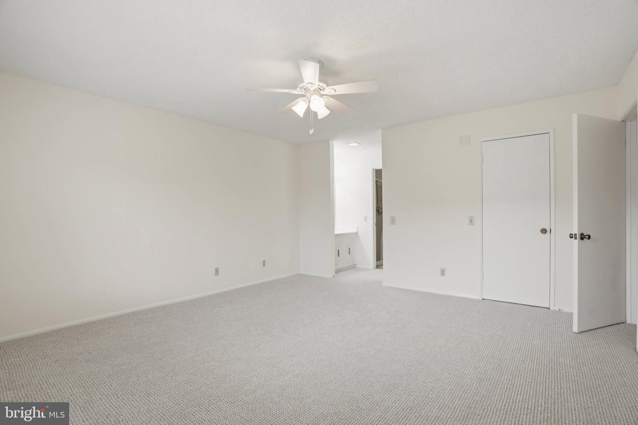 3501 Forest Edge Drive, Unit 142G Silver Spring, MD 20906 - Photo 16 of 30 an empty room with closet and a ceiling fan