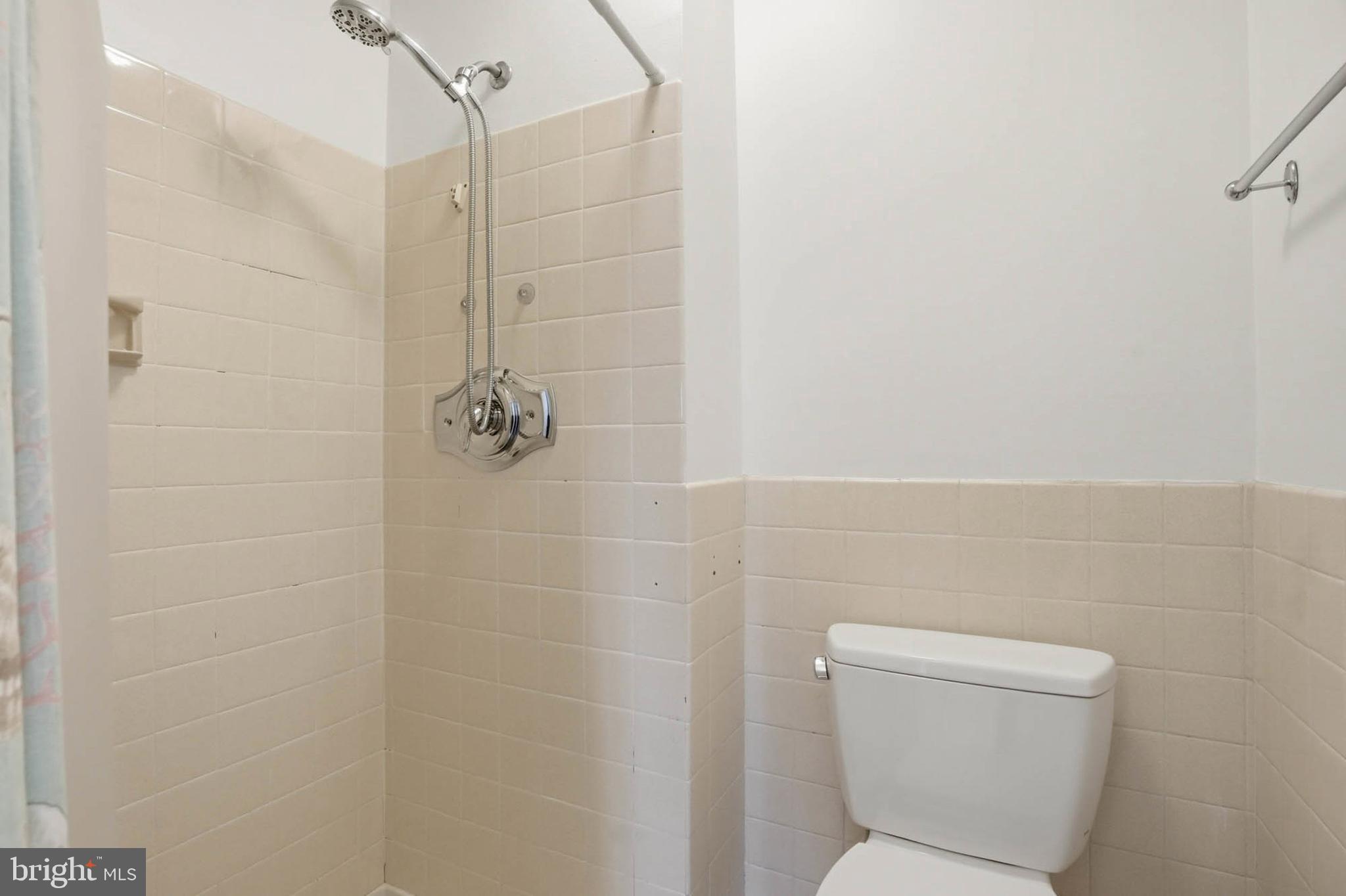 3501 Forest Edge Drive, Unit 142G Silver Spring, MD 20906 - Photo 18 of 30 a bathroom with a toilet and a shower