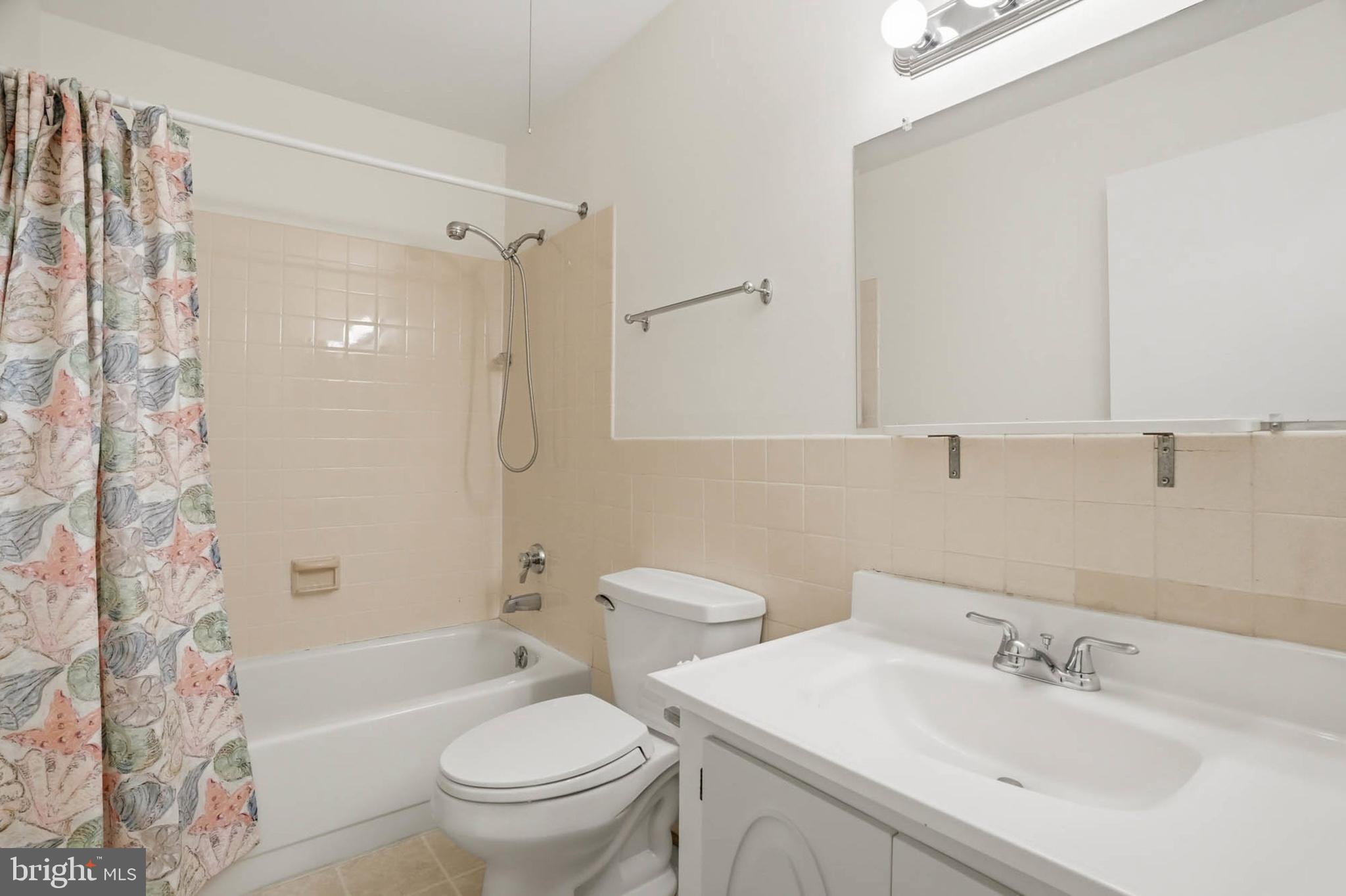 3501 Forest Edge Drive, Unit 142G Silver Spring, MD 20906 - Photo 25 of 30 a bathroom with a sink toilet and shower