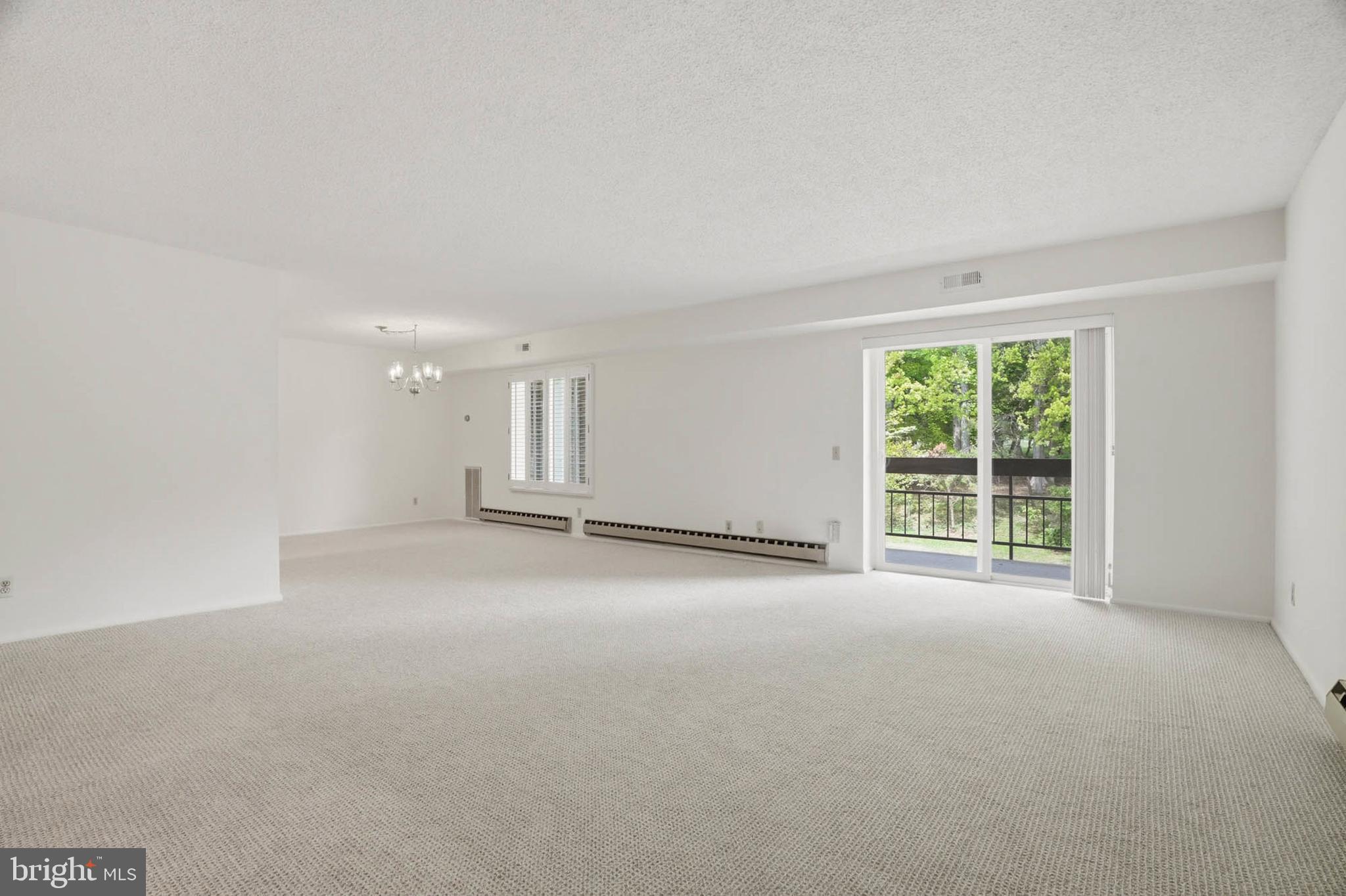 3501 Forest Edge Drive, Unit 142G Silver Spring, MD 20906 - Photo 4 of 30 a view of empty room with a window