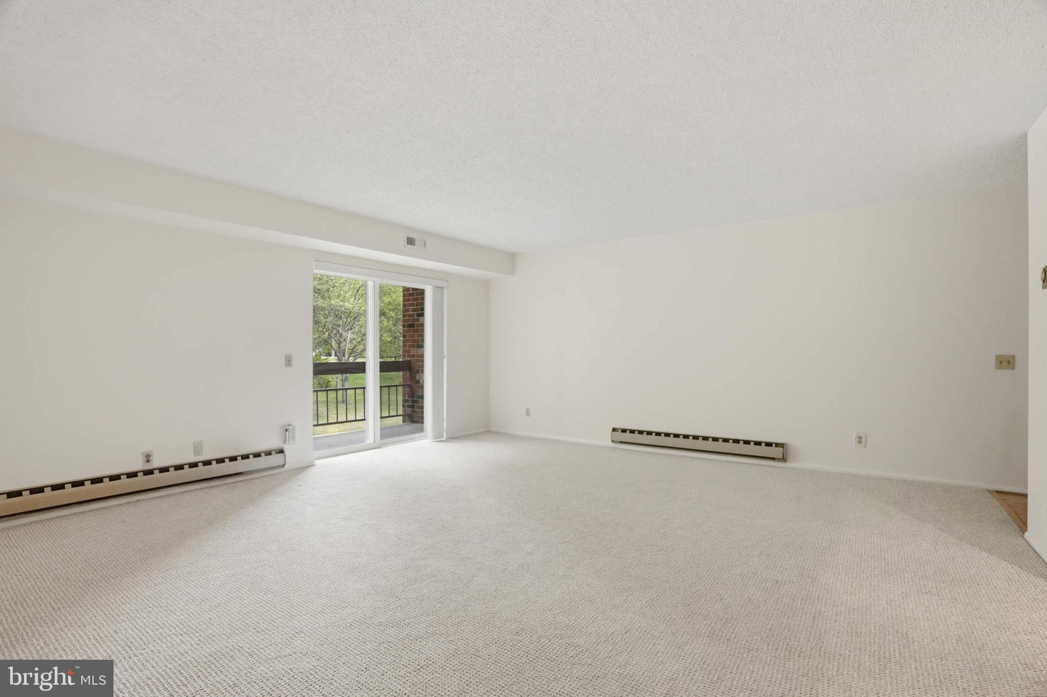 3501 Forest Edge Drive, Unit 142G Silver Spring, MD 20906 - Photo 5 of 30 a view of an empty room with a window