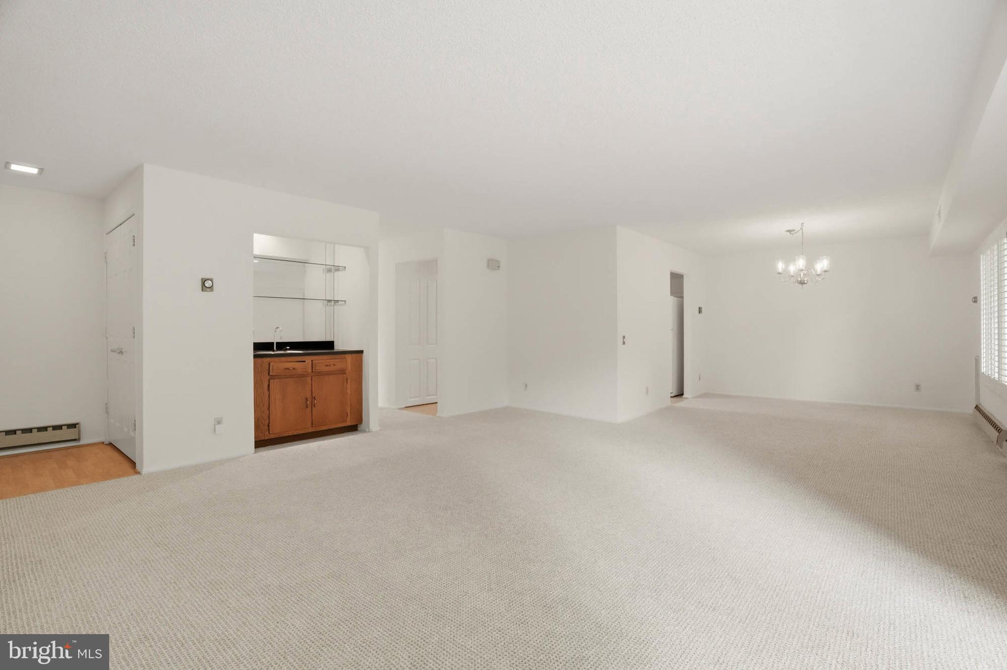 3501 Forest Edge Drive, Unit 142G Silver Spring, MD 20906 - Photo 7 of 30 a view of an empty room with a kitchen