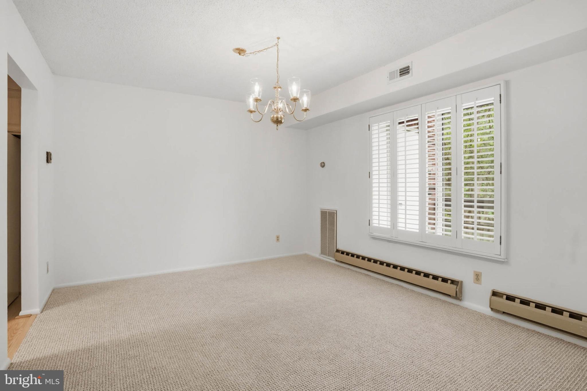 3501 Forest Edge Drive, Unit 142G Silver Spring, MD 20906 - Photo 9 of 30 a view of an empty room with a window