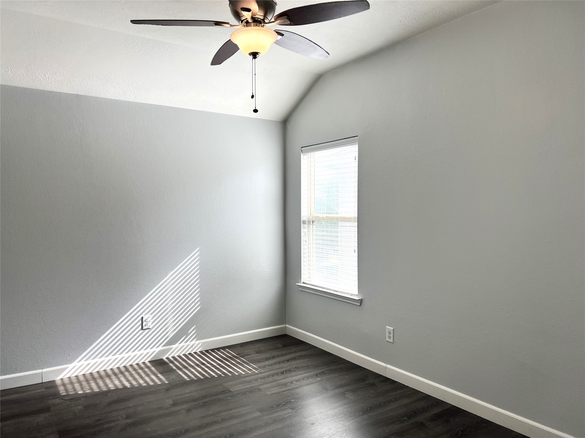9111 Fuqua Ridge Lane Houston, TX 77075 - Photo 18 of 21 an empty room with wooden floor fan and windows