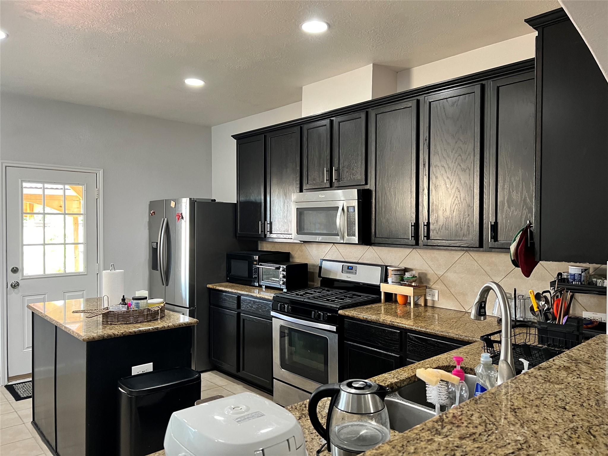 9111 Fuqua Ridge Lane Houston, TX 77075 - Photo 8 of 21 a kitchen with a refrigerator sink and microwave