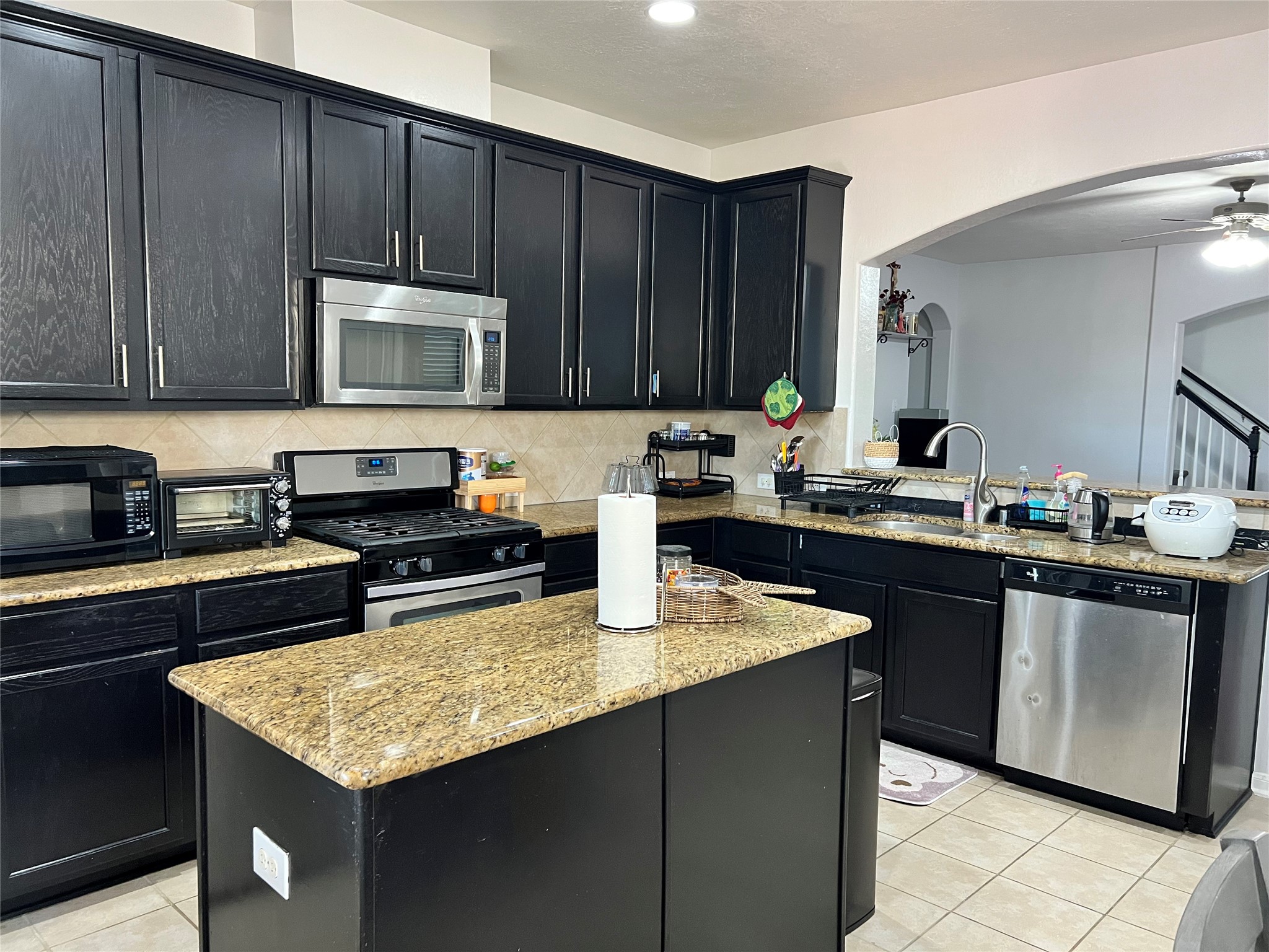 9111 Fuqua Ridge Lane Houston, TX 77075 - Photo 9 of 21 a kitchen with kitchen island granite countertop a sink dishwasher stove and cabinets with wooden floor