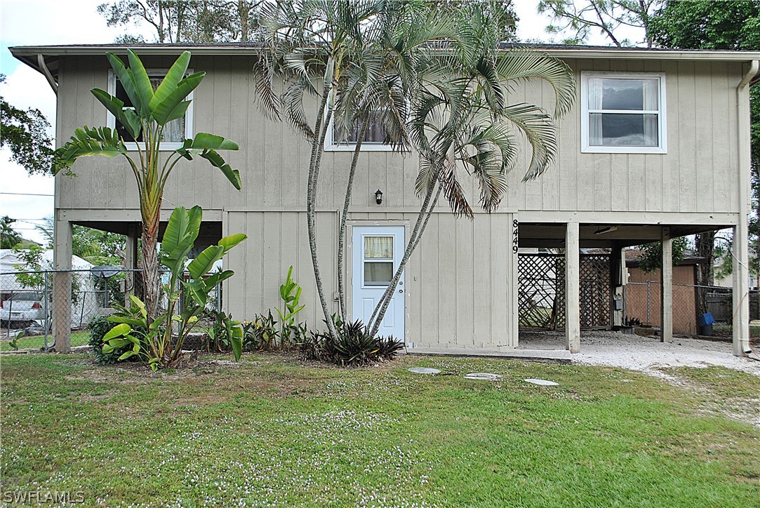 8449 Matanzas Road Fort Myers, FL 33967 - Photo 1 of 6 a front view of house with an garden