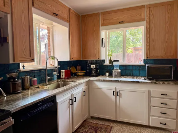 a kitchen with stainless steel appliances granite countertop a refrigerator and a stove