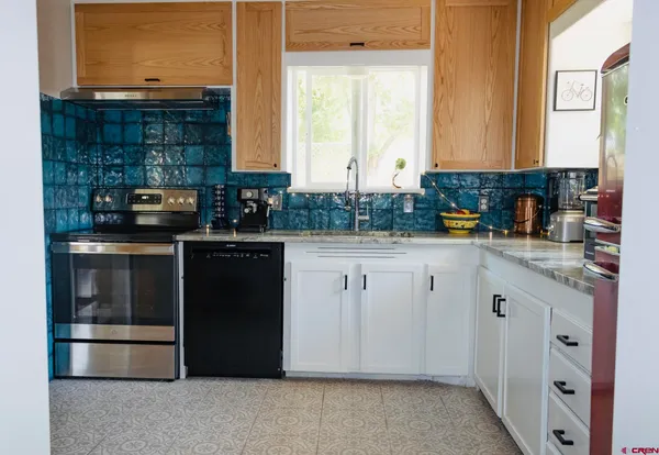 a close view of a sink a stove and storage with a stove
