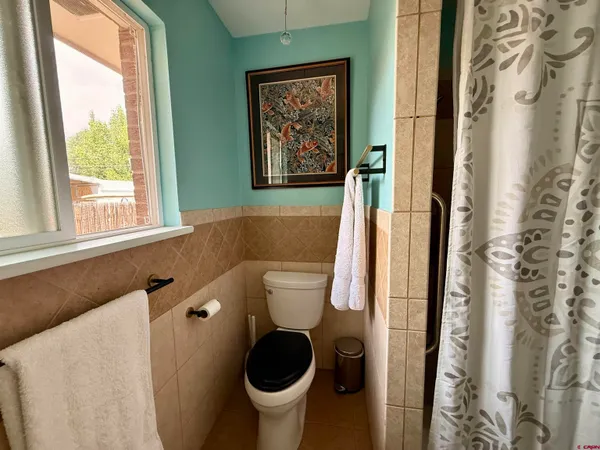 a bedroom with a bed and a wooden floor