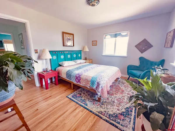 a bedroom with a bed rug and a window