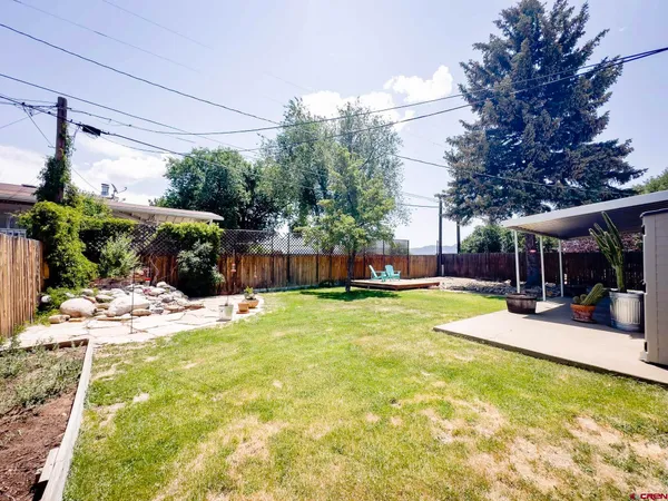 a view of a chair and table in backyard