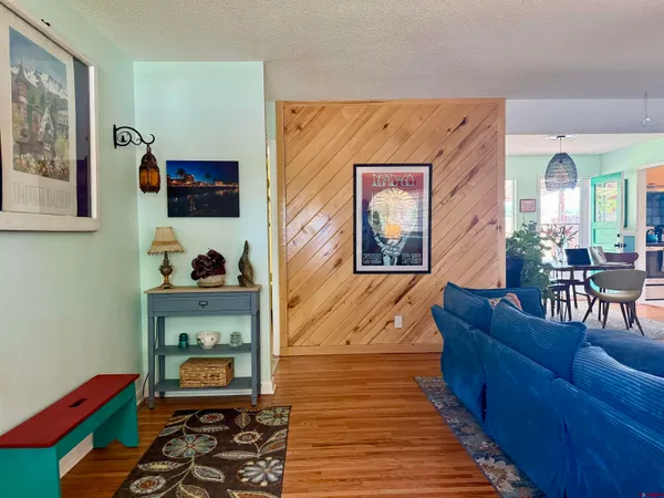 a living room with furniture and a wooden floor