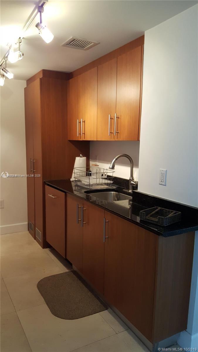 10275 Collins Avenue, Unit 1534 Bal Harbour, FL 33154 - Photo 6 of 33 kitchen with washer and dryer