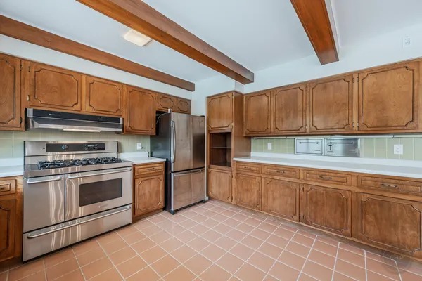 a kitchen with stainless steel appliances kitchen island granite countertop a sink and cabinets