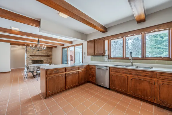 a kitchen with stainless steel appliances granite countertop a sink a stove and a refrigerator