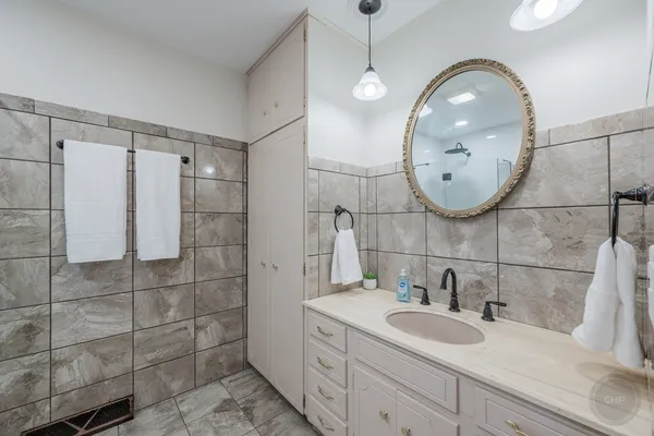 a bathroom with a sink double vanity granite and a mirror