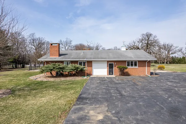 a front view of a house with a garden and porch