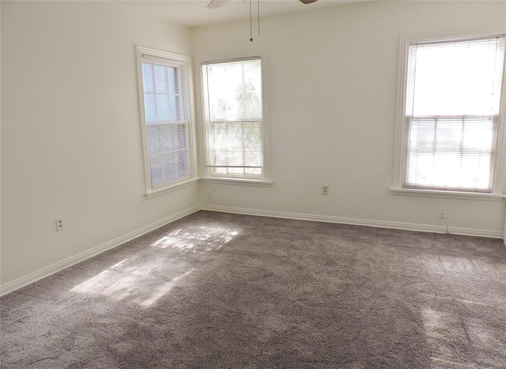 3425 Westcliff Road South Fort Worth, TX 76109 - Photo 14 of 22 Spare room with dark colored carpet, plenty of natural light, and ceiling fan