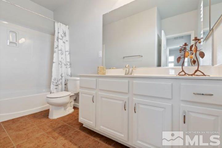 1700 Wind Ranch Road, Unit C Reno, NV 89521 - Photo 17 of 19 a bathroom with a toilet sink and mirror