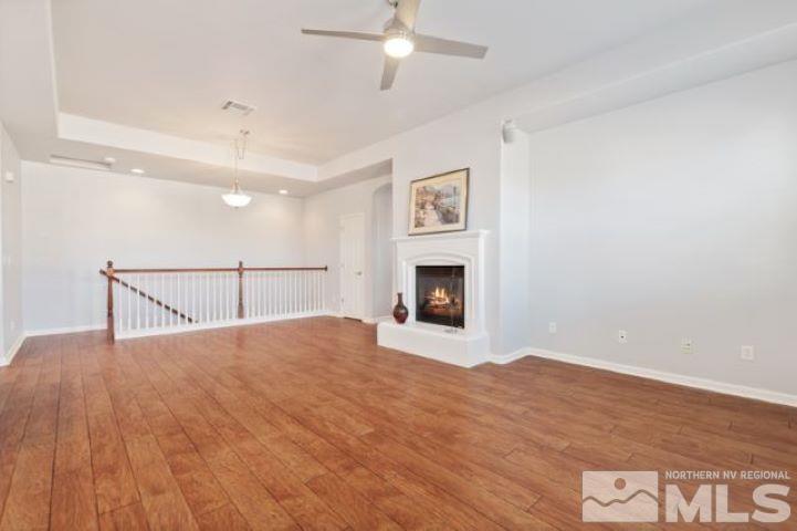 1700 Wind Ranch Road, Unit C Reno, NV 89521 - Photo 8 of 19 a view of empty room with wooden floor and fireplace