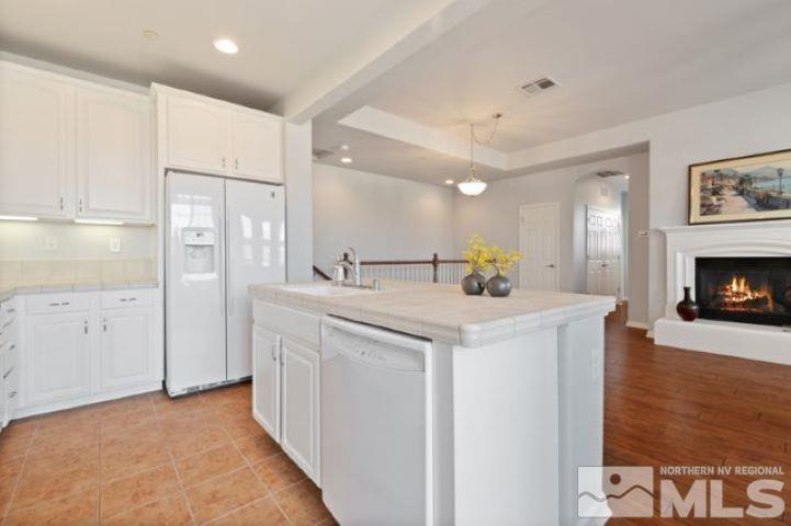 1700 Wind Ranch Road, Unit C Reno, NV 89521 - Photo 10 of 19 a view of a kitchen with a sink and a refrigerator