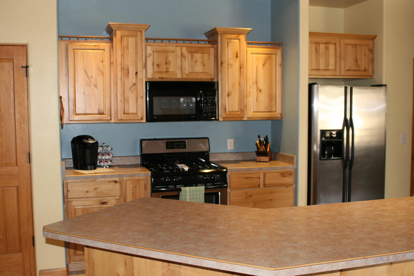 407 Kismet Street, Unit NO # Ridgway, CO 81432 - Photo 3 of 34 a kitchen with stainless steel appliances granite countertop a refrigerator a stove top oven a sink and dishwasher