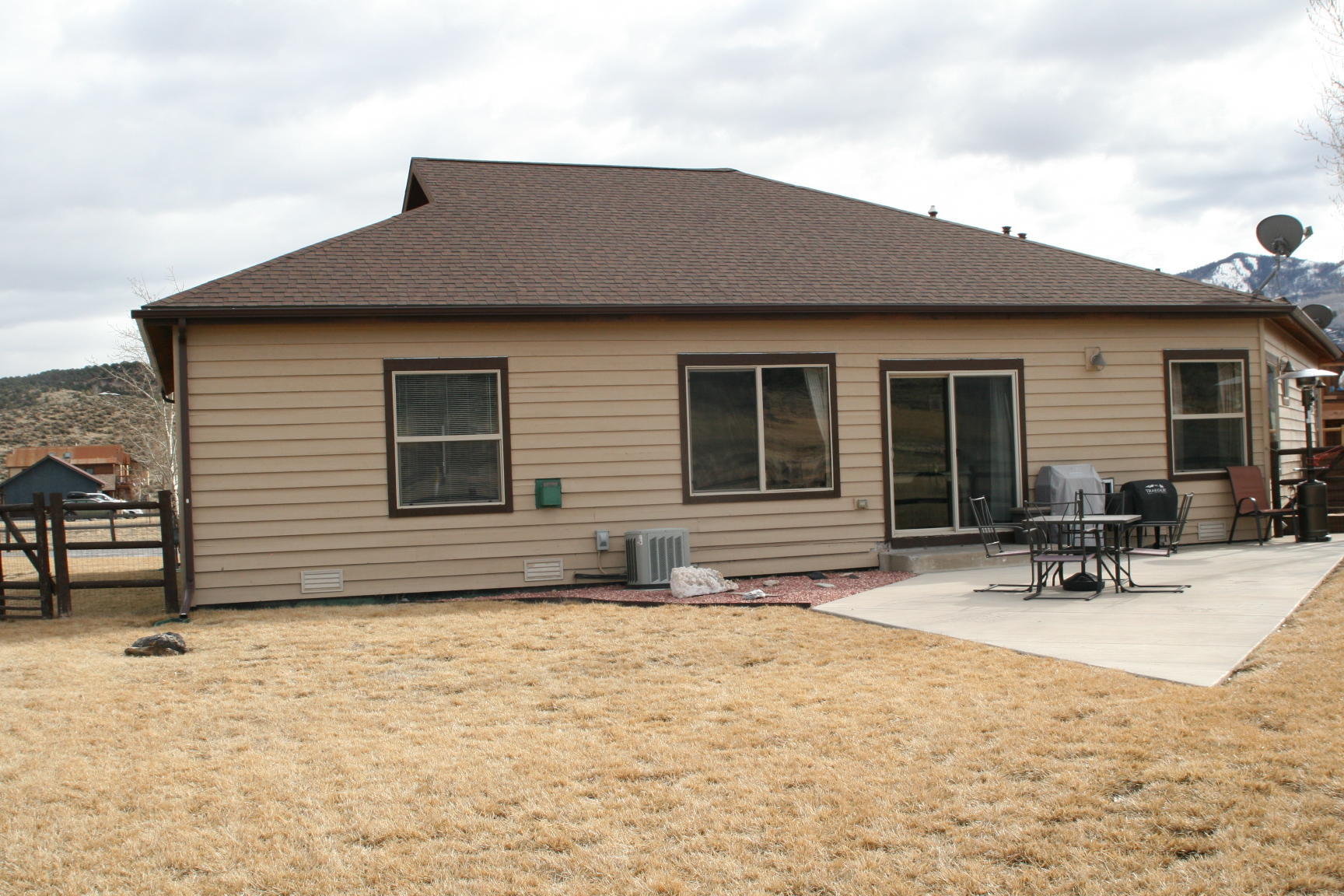 407 Kismet Street, Unit NO # Ridgway, CO 81432 - Photo 33 of 34 a backyard of a house with table and chairs