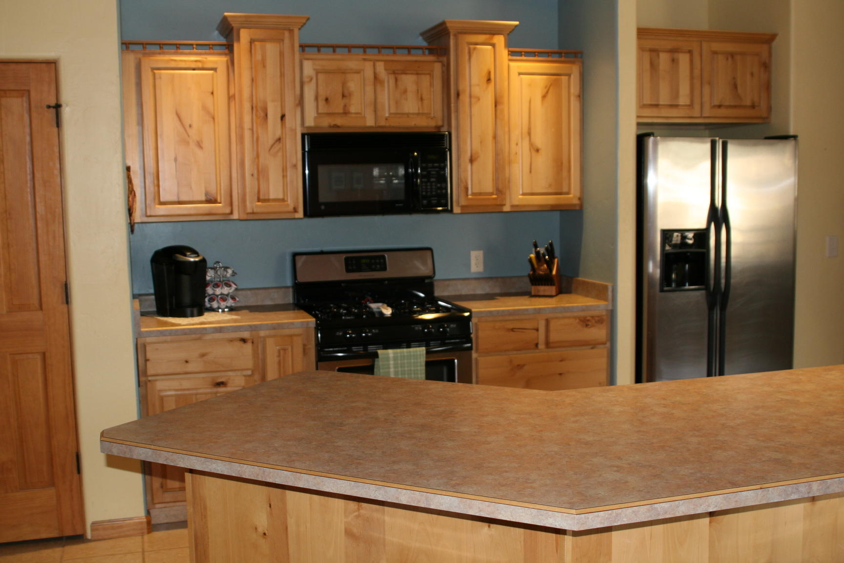 407 Kismet Street, Unit NO # Ridgway, CO 81432 - Photo 6 of 34 a kitchen with stainless steel appliances a stove a refrigerator a sink a stove and cabinets