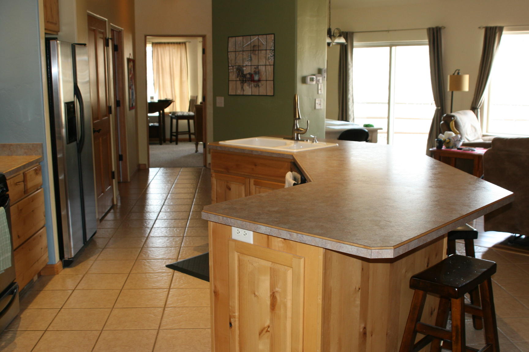 407 Kismet Street, Unit NO # Ridgway, CO 81432 - Photo 7 of 34 a kitchen with stainless steel appliances kitchen island granite countertop a refrigerator a stove and a sink