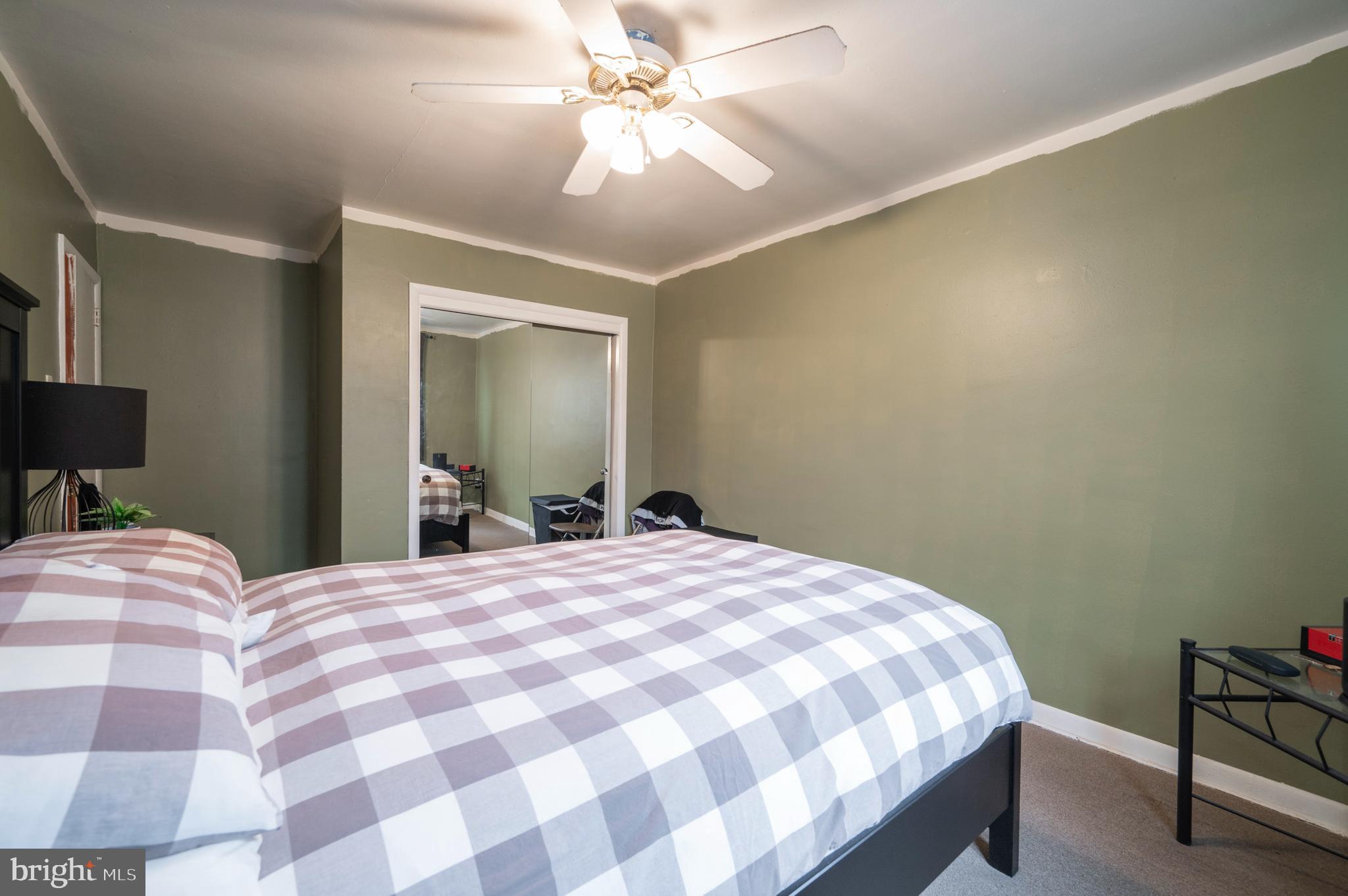 2588 Cranston Road Philadelphia, PA 19131 - Photo 15 of 38 a bedroom with a bed and a chandelier