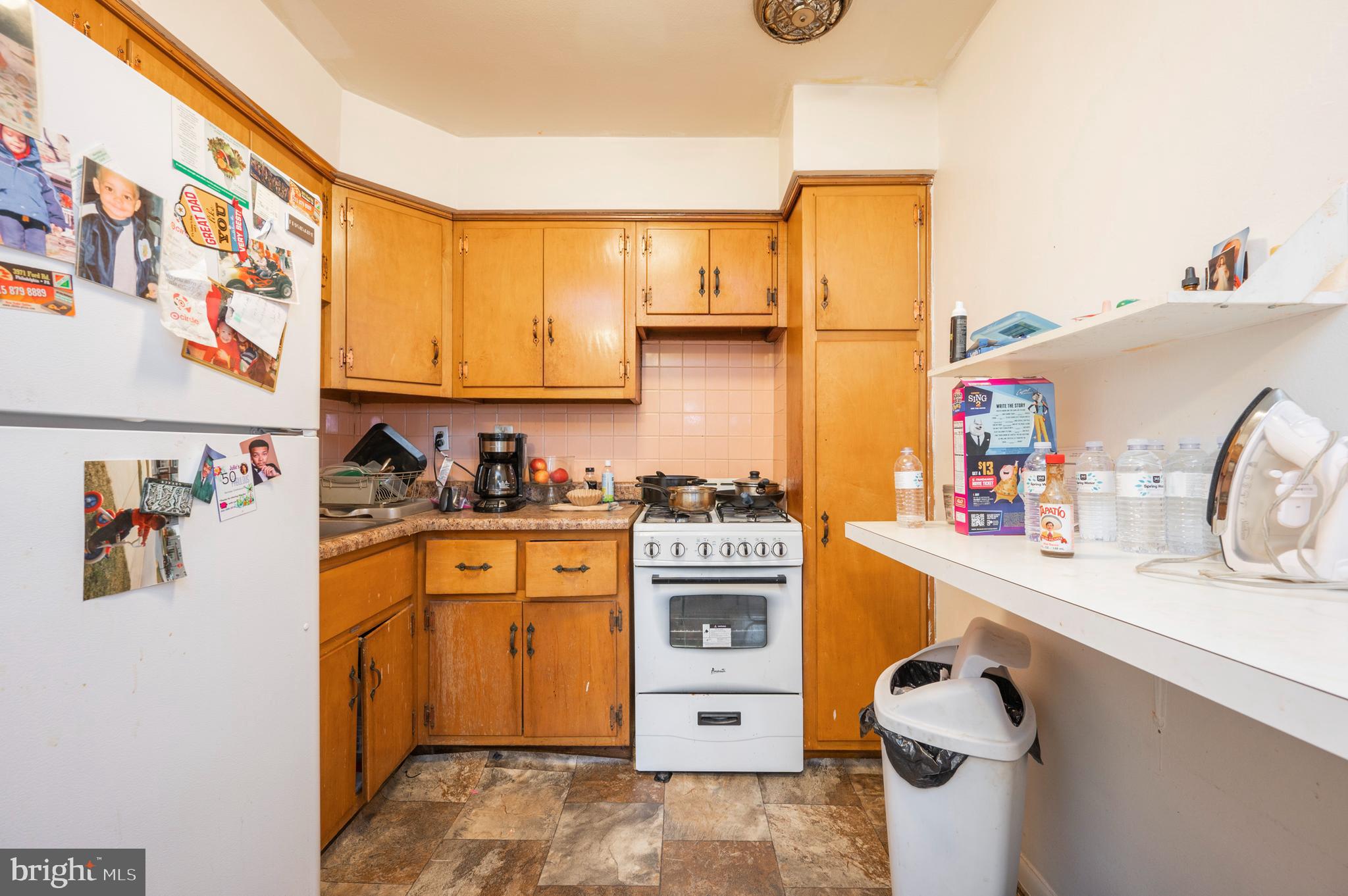 2588 Cranston Road Philadelphia, PA 19131 - Photo 23 of 38 a kitchen with a sink a stove cabinets and a wooden floor