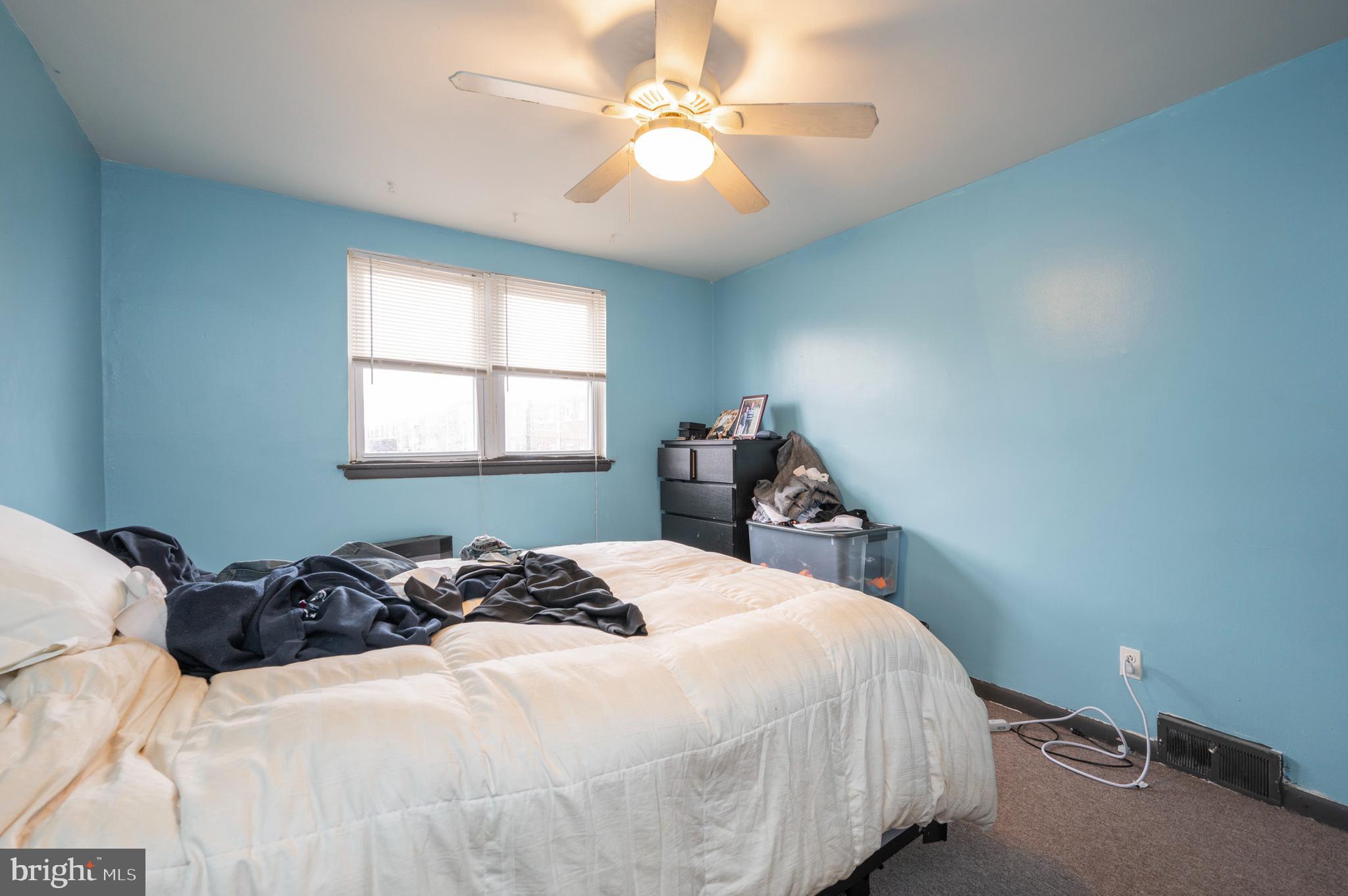 2588 Cranston Road Philadelphia, PA 19131 - Photo 30 of 38 a bedroom with a bed and a chandelier