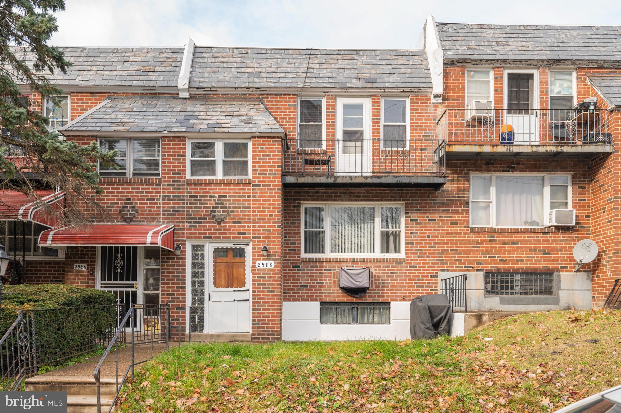 2588 Cranston Road Philadelphia, PA 19131 - Photo 38 of 38 a front view of a residential apartment building with a yard