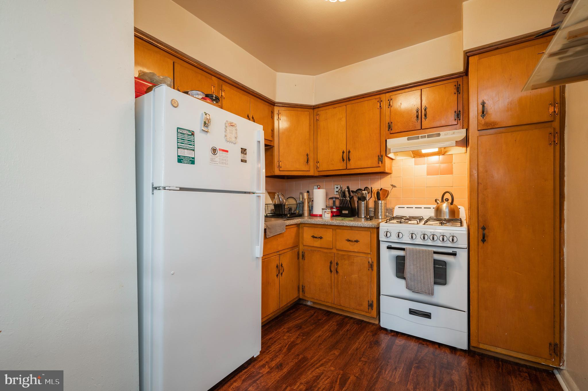 2588 Cranston Road Philadelphia, PA 19131 - Photo 7 of 38 a kitchen with stainless steel appliances a refrigerator sink and cabinets