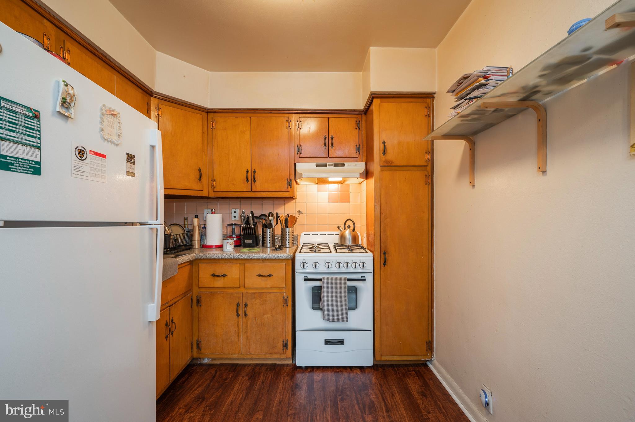 2588 Cranston Road Philadelphia, PA 19131 - Photo 8 of 38 a kitchen with a refrigerator a stove and wooden floor