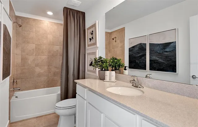 a bathroom with a granite countertop sink and a large mirror