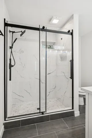 a bathroom with a glass shower door