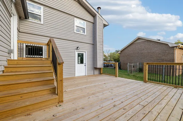 a view of a house with wooden deck