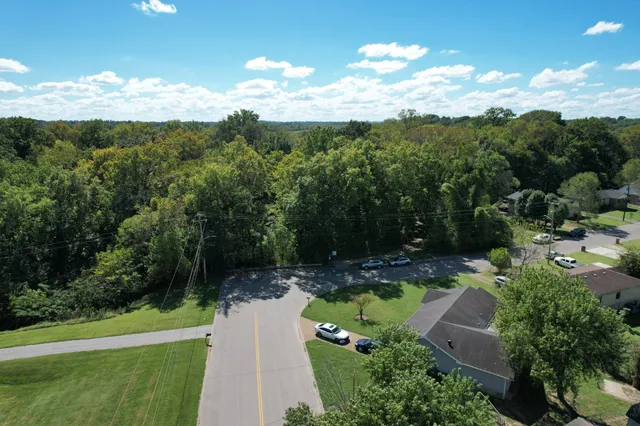 a view of a swimming pool with lawn chairs under an umbrella