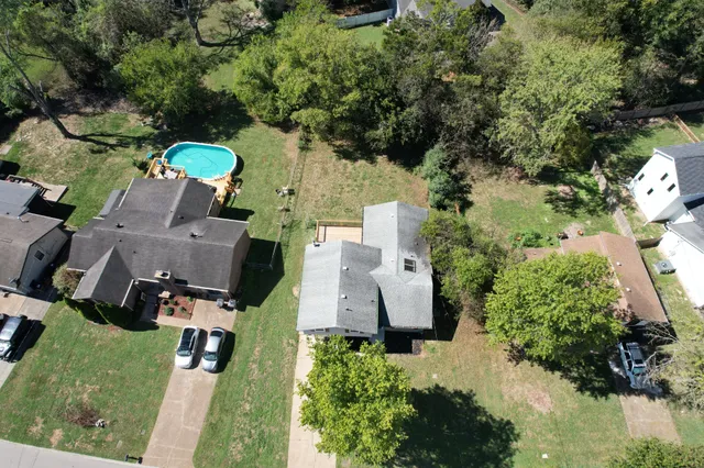 an aerial view of a house with a yard basket ball court and outdoor seating